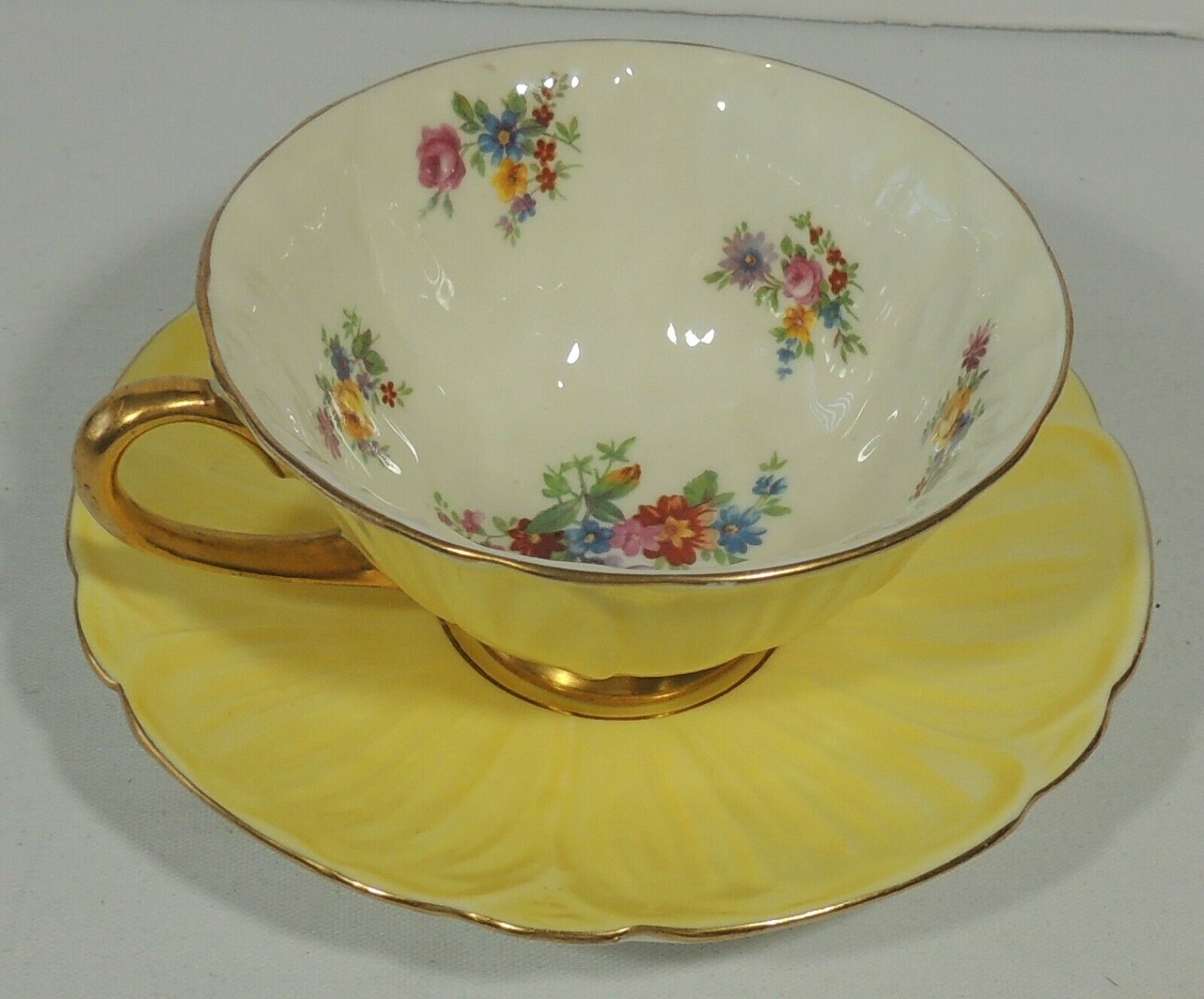 Shelley England Oleander Shape Yellow Floral Footed Gold Trim Teacup & Saucer